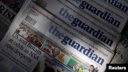 Copies of the Guardian newspaper are displayed at a news agent in London, Aug. 21 2013.