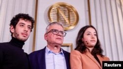 The husband and children of this year's winner of the Nobel Peace Prize, Ali, Taghi and Kiana Rahmani, attend a press conference at the Nobel Institute in Oslo, Norway, on Dec. 9, 2023. Their wife and mother, Narges Mohammadi, is jailed in Iran.