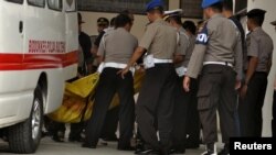Police carry body bags — one of which is believed to contain the remains of Santoso, the country's most wanted militant, killed in a clash with security forces — from an ambulance at a hospital in Palu, Central Sulawesi, Indonesia, July 19, 2016.