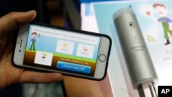 The Archibald e-gardener app, left, and Super Sensor, right, are on display at the Connected Garden booth during CES Unveiled at CES International, Sunday, Jan. 6, 2019, in Las Vegas.