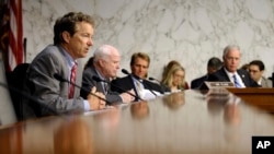 Senate Foreign Relations Committee members, from left, Sen. Rand Paul, Sen. John McCain, Sen. Jeff Flake, and Sen. Ron Johnson listen on Capitol Hill, Sept. 4, 2013, during the committee's hearing to consider the authorization for use of military force in Syria.