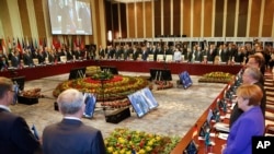 Leaders stand for a minute of silence for the victims of a deadly attack in the French city of Nice, before the opening session of the Asia-Europe Meeting (ASEM) summit in Ulaanbaatar, Mongolia, Friday, July 15, 2016.