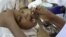 FILE - A health worker gives a child an oral polio vaccine in Kano, Nigeria.