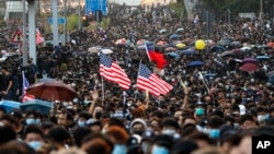 Pro-democracy protesters flood a street during a rally in Hong Kong, Dec. 1, 2019. 