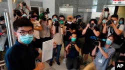 Hong Kong pro-democracy activist Joshua Wong poses for a picture with the nomination papers as he files his candidacy in Legislative Council elections due in September in Hong Kong, July 20, 2020. 