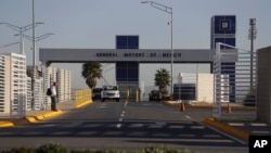 FILE - Cars exit the General Motors assembly plant in Villa de Reyes, outside San Luis Potosi, Mexico, Jan. 4, 2017. Mexico’s growing share of the auto market is a sore spot for President Donald Trump, who has threatened to impose border taxes on Mexican imports to force companies to make cars in the U.S. 
