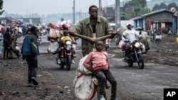People displaced by the fighting with M23 rebels make their way to the center of Goma, Congo, Jan. 26, 2025.