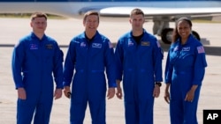 FILE - The SpaceX crew, from left, cosmonaut Alexander Grebenkin, pilot Michael Barratt, commander Matthew Dominick and mission specialist Jeanette Epps pose after arriving at the Kennedy Space Center in Cape Canaveral, Florida, Feb. 25, 2024.