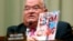 U.S. Representative Billy Long holds up a magazine with an Ebola headline at a House Energy and Commerce Oversight and Investigations Subcommittee hearing.