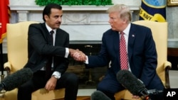 President Donald Trump shakes hands with Emir of Qatar Sheikh Tamim bin Hamad al-Thani in the Oval Office of the White House, April 10, 2018, in Washington.
