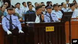 Former Politburo member and party leader of Chongqing, Bo Xilai, sits in the defendant seat and listens Wang Lijun's testimony, Aug. 24, 2013.