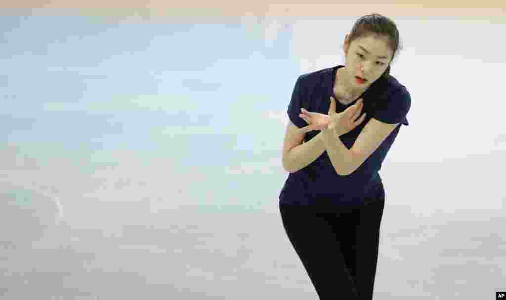 Yuna Kim of South Korea skates during a practice session at the figure stating practice rink at the 2014 Winter Olympics, Feb. 17, 2014.