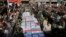 Flag-draped caskets of those who died in Saturday's terror attack on a military parade are laid out during a mass funeral, in the southwestern city of Ahvaz, Iran, Sept. 24, 2018. 