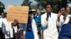FILE - Doctors and medical staff march to Zimbabwe's Parliament, Sept. 19, 2019, in Harare demanding the safe return of Peter Magombeyi, whom protesters believe was taken because of his role organizing strikes to demand better pay and working conditions.
