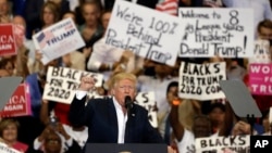 President Donald Trump pumps his fist to supporters at the conclusion of a campaign rally, Feb. 18, 2017, in Melbourne, Fla. 