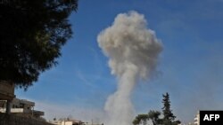  Smoke billows over the town of Saraqeb in the eastern part of Idlib province in northwestern Syria, following bombardment by Syrian government forces, Feb. 27, 2020.