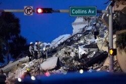 Rescue workers look through the rubble where a wing of a 12-story beachfront condo building collapsed, June 24, 2021, in the Surfside area of Miami.