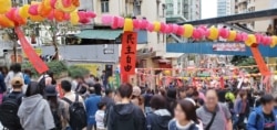 Festive red strip of paper dangling in a Chinese new year market says: "democracy and freedoms."