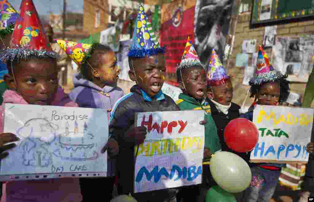 A group of kindergarten children sing Happy Birthday outside the Mediclinic Heart Hospital where the former South African President is being treated in Pretoria, South Africa July 18, 2013.