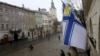 FILE - A Ukrainian Naval Forces flag is on display at the city hall building in Lviv, in support of Ukrainian military sailors based in Crimea, March 6, 2014.
