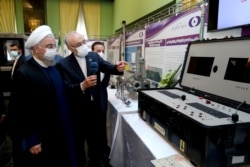 FILE - Iranian President Hassan Rouhani reviews his country's nuclear achievements, in Tehran, April 10, 2021. ​The Biden administration is weighing a rollback of some Trump-era sanctions imposed on Iran to encourage compliance with a nuclear pact.