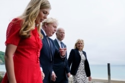 President Joe Biden and first lady Jill Biden are greeted and walk with British Prime Minister Boris Johnson and his wife Carrie Johnson, ahead of the G-7 summit, June 10, 2021.