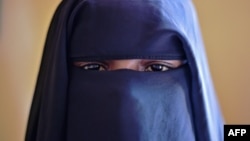 FILE - Fatima, 14, poses at the Elman Centre in Mogadishu, March 24, 2015. After Fatima was raped by a tuk-tuk driver, she was arrested, detained for a month and raped repeatedly by a police officer, she and her aunt said. 