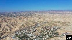 FILE - This Jan. 26, 2020, photo shows a view of the West Bank Jewish settlement of Mitzpe Yeriho. The United Nations Human Rights Council released a list of more than 100 companies it says are operating in Israel's West Bank settlements.