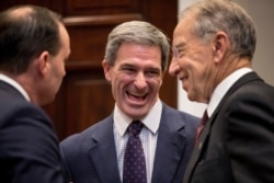 FILE - From left, Sen. Mike Lee, R-Utah, former Virginia Attorney General Ken Cuccinelli, and Sen. Chuck Grassley, R-Iowa, share a laugh, Nov. 14, 2018, before Cuccinelli joined the Trump administration.