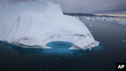 FILE - An iceberg is seen melting off the coast of Ammasalik, Greenland, July 19, 2007.