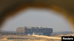 A view shows the stranded container ship Ever Given, one of the world's largest container ships, after it ran aground, in Suez Canal, Egypt, March 28, 2021. 