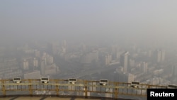 A view from a viewing deck on the China Central Radio and Television Tower shows the city of Beijing in heavy smog, China, November 29, 2015. Heavy smog continues in Beijing on Sunday after a yellow alert of air pollution was issued on Friday, local media reported.