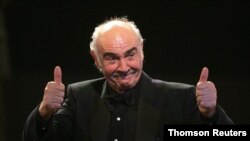 FILE - British actor Connery reacts on stage during European film award ceremony in Berlin, Dec. 3, 2005. 