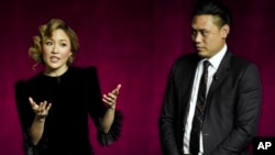 Police arrest a man during a crackdown on anti-coup protesters holding a rally in front of the Myanmar Economic Bank in Mandalay, Myanmar.