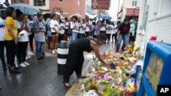 Howard University students pause at the site where Heather Heyer was killed by a car in Charlottesville, Virginia, Aug. 18, 2017. About fifty Howard University students visited the site where Heyer died while protesting a white nationalist rally on Aug. 12, 2017.