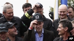 Prince William (center) with members of the Urban Search and Rescue team in Christchurch, New Zealand, March 17, 2011