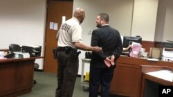 FILE - White nationalist Matthew Heimbach is led away in handcuffs on Tuesday, May 15, 2018 in Louisville, Kentucky, after a judge ruled that he violated the probation he was serving for physically harassing a protester at a 2016 Donald Trump campaign rally. Heimbach was arrested in March on battery charges after a domestic incident in Paoli, Indiana.