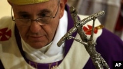 Pope Francis leaves at the end of a Mass on the occasion of his visit to the Parish Church of St. Cirillo Alessandrino, in Rome, Dec. 1, 2013.