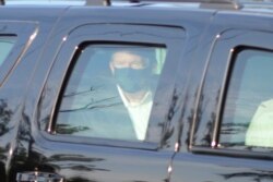 President Donald Trump drives past supporters gathered outside Walter Reed National Military Medical Center in Bethesda, Md., Oct. 4, 2020.