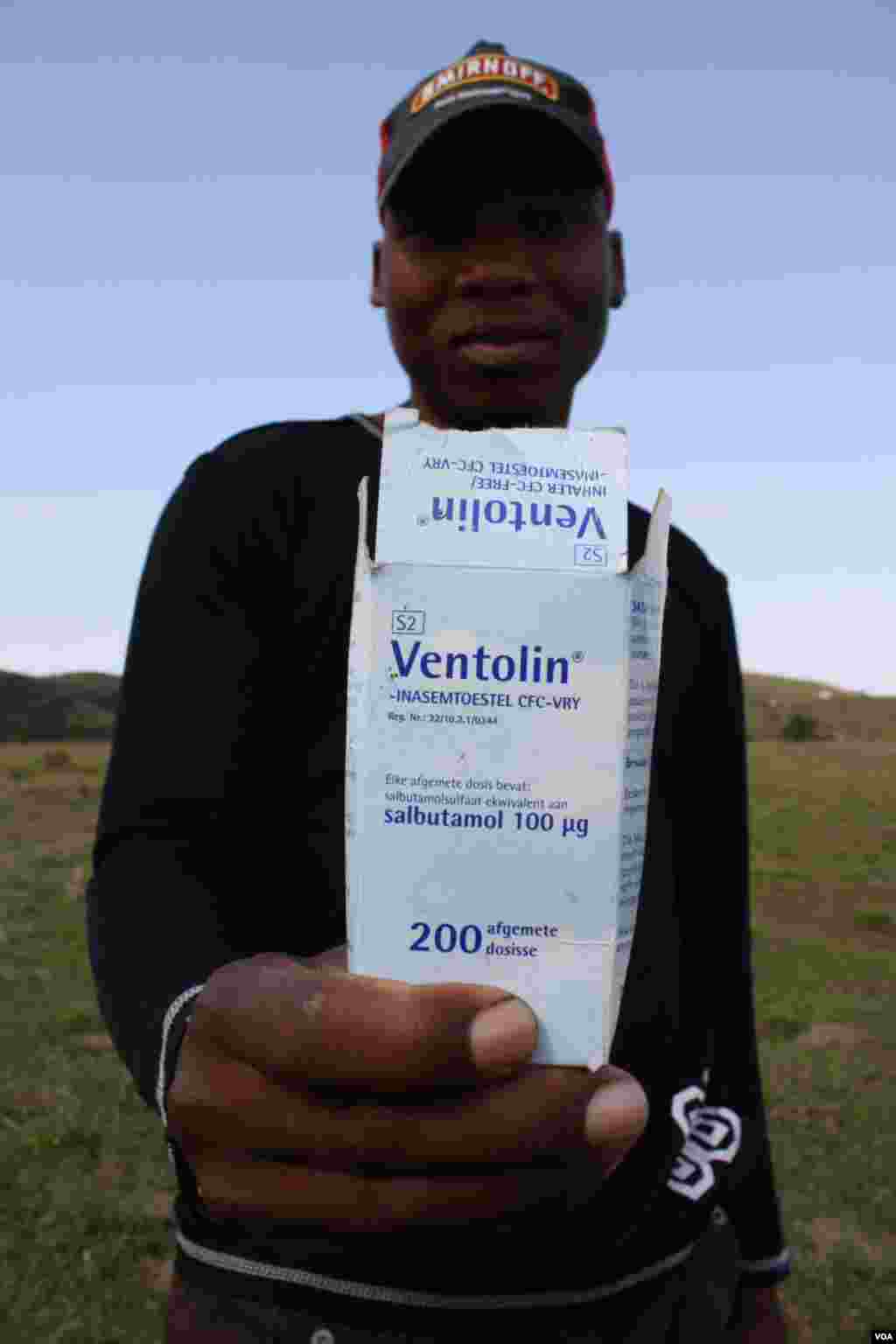 On the way to the clinic, Bongesi Gashe picks up numerous empty medicine boxes and bottles that have been discarded by other ill people who’ve visited the health facility (VOA/D.Taylor)