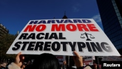 A supporter carrying a "Harvard No More Racial Stereotyping" sign attends the "Rally for the American Dream - Equal Education Rights for All," ahead of the start of the trial in a lawsuit accusing Harvard University of discriminating against Asian-America