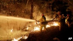 Fire crews battle a wildfire in Santa Rosa, California, Oct. 14, 2017.