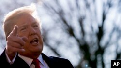 FILE - President Donald Trump speaks to reporters before boarding Marine One on the South Lawn of the White House in Washington, March 13, 2018, to travel to Andrews Air Force Base, Maryland.