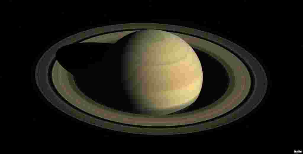 This Aug. 12, 2009 composite image made available by NASA shows Saturn in equinox seen by the approaching Cassini spacecraft. Saturn's equinox occurs only once in about 15 Earth years.