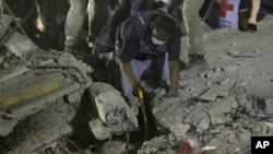 Rescue workers search for people trapped in a collapsed building in the Piedad Narvarte neighborhood of Mexico City, Tuesday, Sept. 19, 2017.