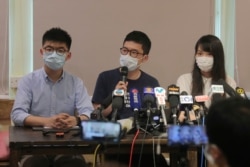 Pro-democracy activists, from left; Joshua Wong, Nathan Law and Agnes Chow attend a press conference in Hong Kong, May 30, 2020.