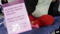 Gloria, a 22-year-old migrant from Honduras 8 months pregnant with her first child, sits on a cot in the Humanitarian Respite Center run by Catholic Charities across the bus station in McAllen, Texas, on Dec. 15, 2022.