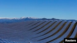 FILE - Solar panels are used to produce renewable energy at the photovoltaic park in Les Mees, in the department of Alpes-de-Haute-Provence, France, March 31, 2015.