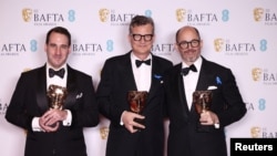 James Friend poses with his award for Best Cinematography for 'All Quiet on the Western Front' alongside Malte Grunert and Edward Berger as they pose with their awards for Best Film Not In The English Language for 'All Quiet on the Western Front' in London, Feb. 19, 2023. 