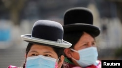 Aymara indigenous women wearing protective masks are seen at the Plaza Murillo during a celebration marking the 195th anniversary of Bolivia foundation at the presidential palace, amid the COVID-19 outbreak, in La Paz, Bolivia, Aug. 6, 2020.